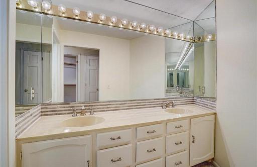 Primary bath features a dual-sink vanity with abundant storage.