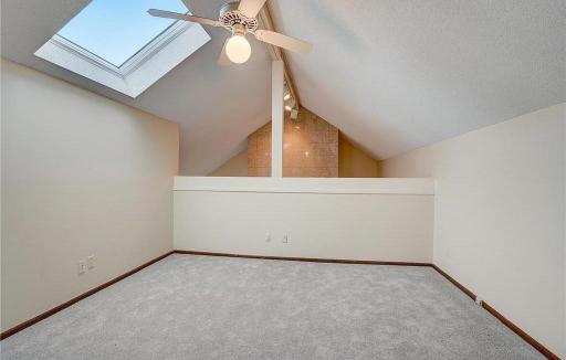 Light-filled bonus loft on the upper level, featuring a skylight and views of the living roomâperfect for a cozy reading nook, office, or flex space.