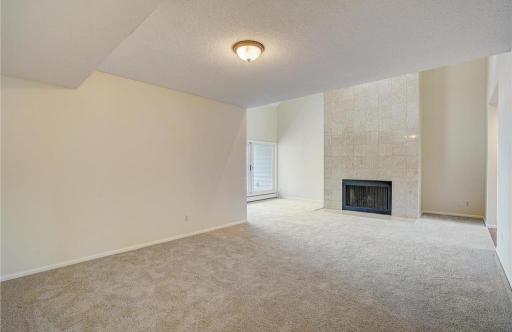 Large living room with seamless flow into the dining room and direct access to the balcony.