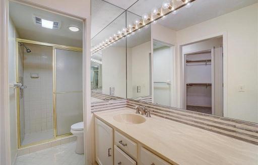 Primary bath features a large vanity with a separate room for the stool and shower.