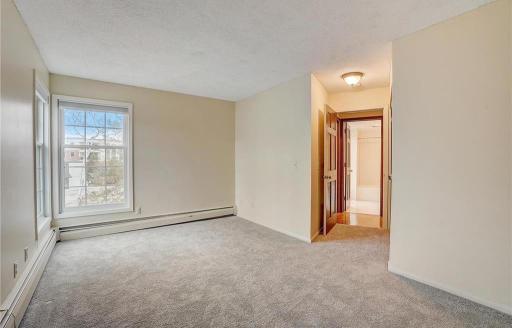 Main-level Bedroom 1 with the full bathroom conveniently located directly across the hallway.