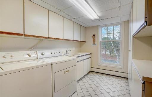 Generous in-unit laundry room with a sink and plenty of storage, making everyday tasks easier and more efficient.