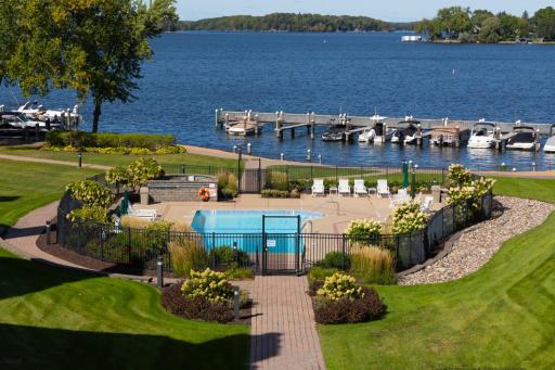The community pool sits directly along the shoreline, creating a resort-style experience with peaceful views of Lake Minnetonka.