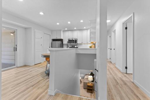 View to kitchen, stairs to LL