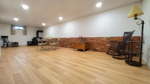 Large family room downstairs with new flooring and fresh paint