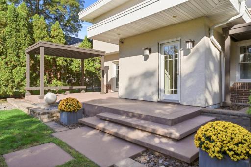 The pergola offers shade and a quiet spot to unwind.