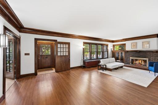 Oversized crown molding, beautiful hardwood floors and a brick, gas burning fireplace welcome guests.