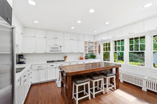 The large eat-in kitchen has floor to ceiling cabinets, granite countertops and center island.