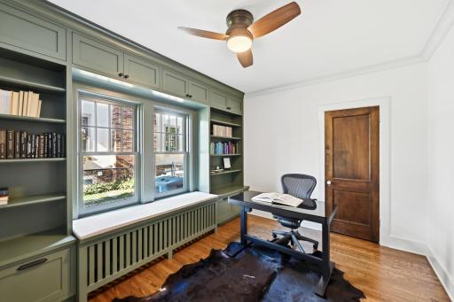 The newly renovated office has new windows, hardwood floors and custom bookshelves.