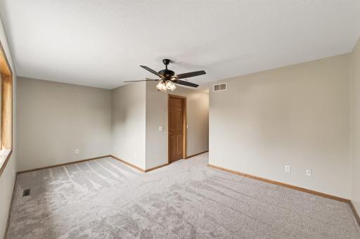 Primary Suite: The spacious primary bedroom features new carpet, a generous walk-in closet, and a private full en-suite bath.