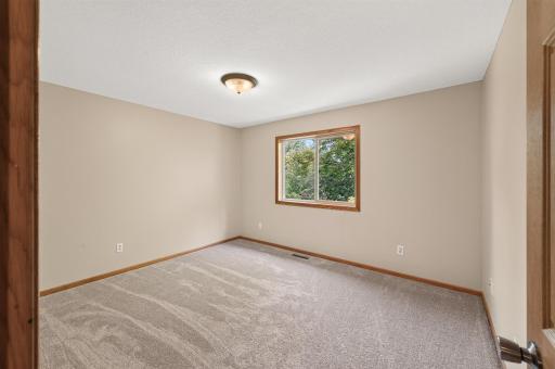 Bedroom 2: One of three bedrooms on the same upper level, this sunny room includes brand-new carpet and its own walk-in closet.