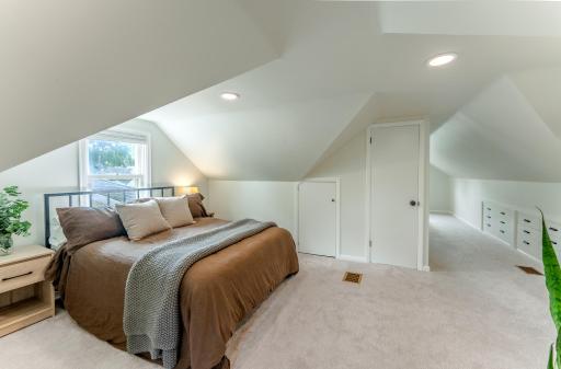 Primary bedroom with built in storage and dual closets.
