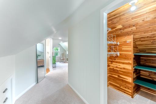 Hallway to primary bedroom with walk in closet.