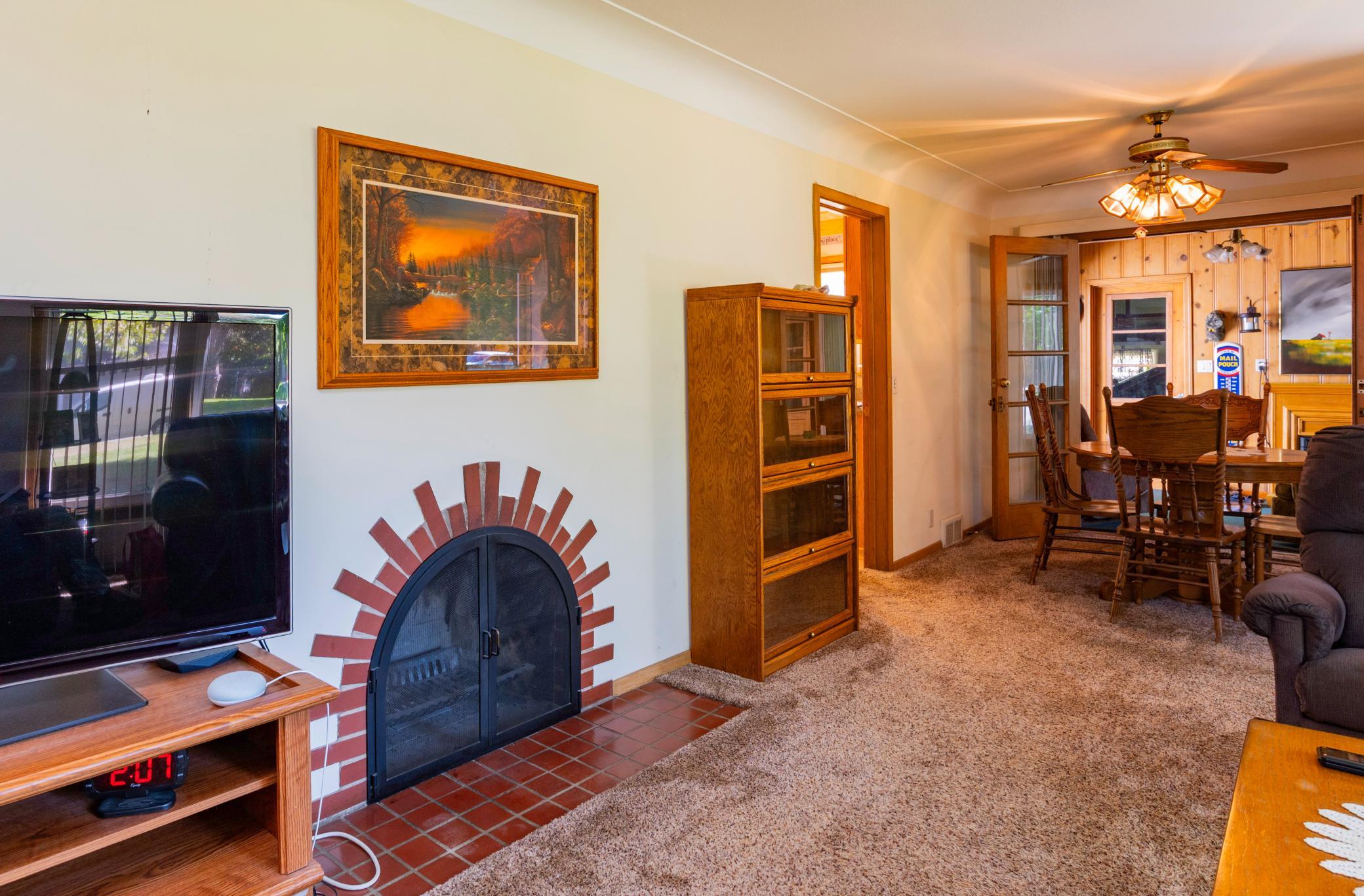 Living Room features a wood burning fireplace, Dining area with french doors that open to the Breezeway/Porch.