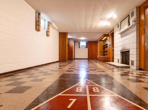Lower level family room with a game built right into the flooring.