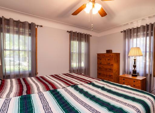 The main floor primary bedroom is large enough for a king size bed. It features 3 windows, and cove ceilings.