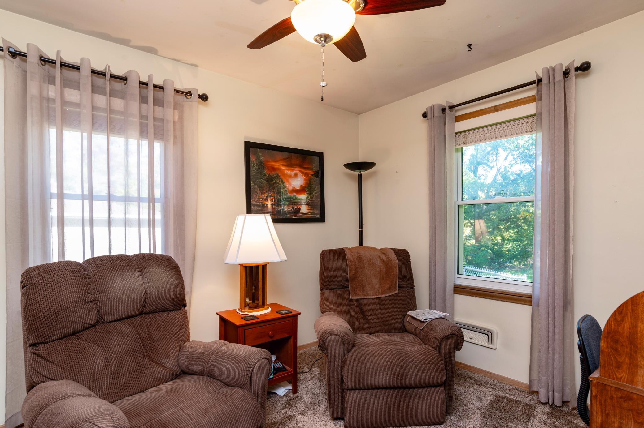 The second main floor bedroom has two windows and is currently being used as an office and TV room.