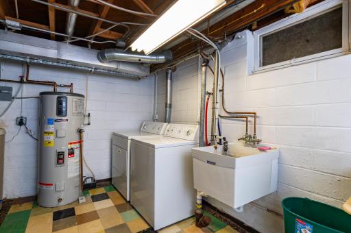 Lower level laundry with newer water heater, water softener, furnace and AC.