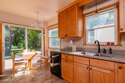 The kitchen is light and bright with two windows and an east facing patio slider door for morning sun. Enough room for eat in kitchen and access to large deck leading to private yard.