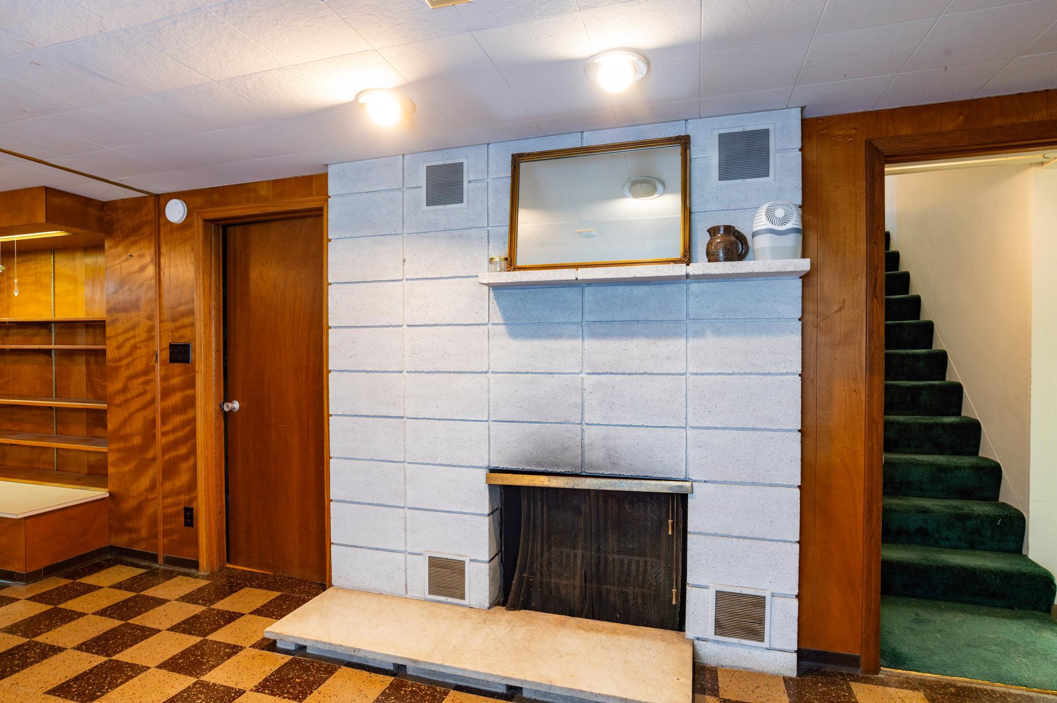 Lower level wood burning fireplace.