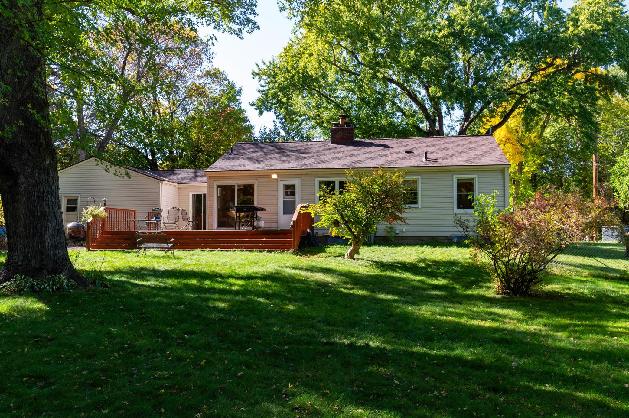 A rear view of the home from the sunny and shady backyard. A great neighborhood with large lots and privacy.
