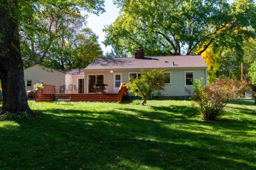 A rear view of the home from the sunny and shady backyard. A great neighborhood with large lots and privacy.