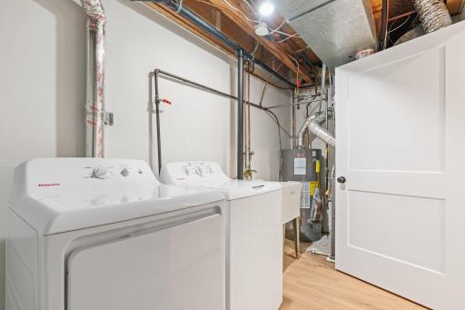Laundry room located across from the primary bedroom