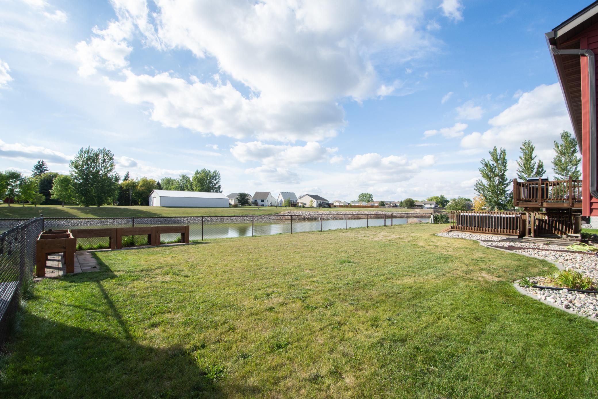 fully fenced yard with pond views