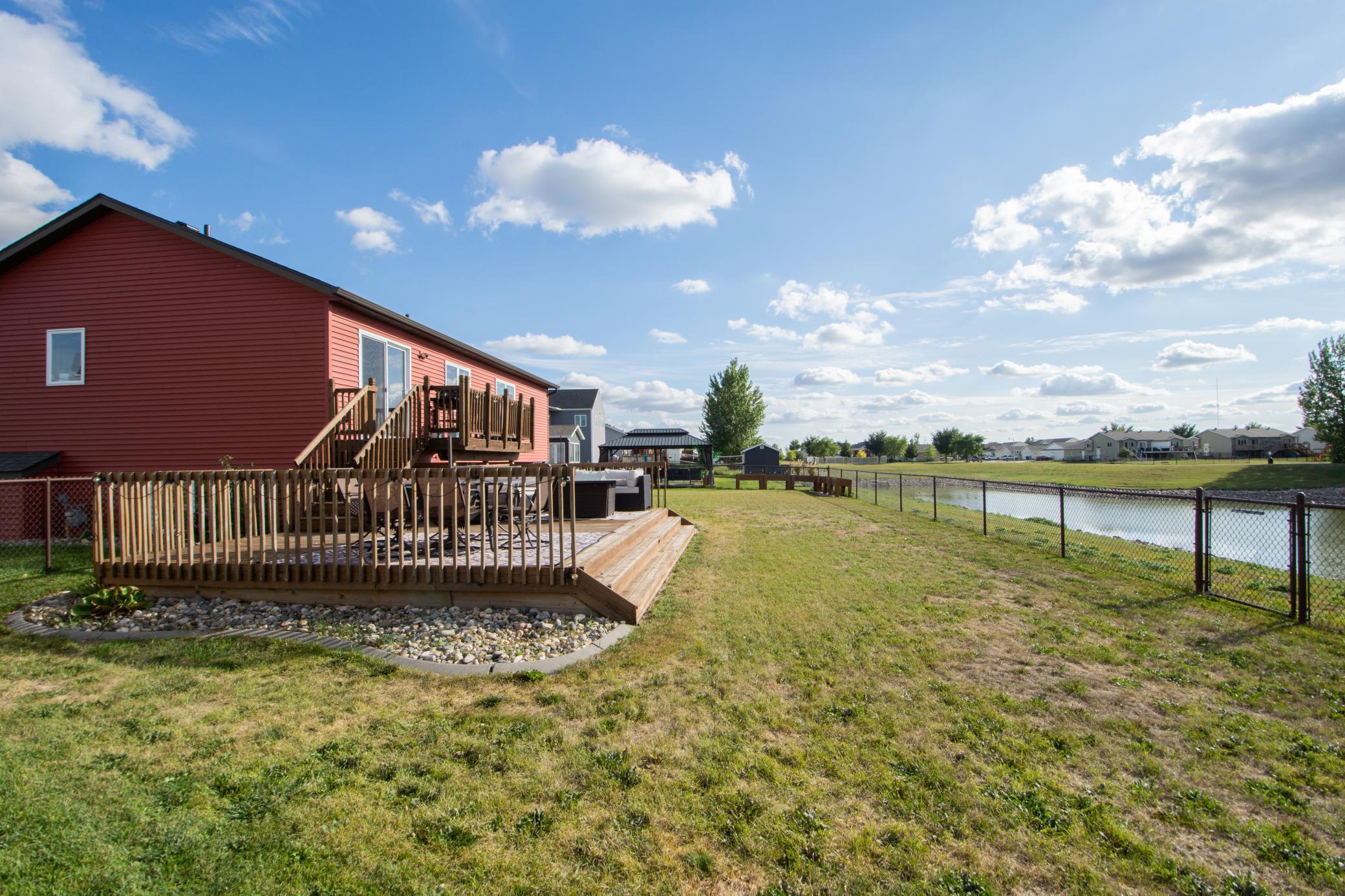 fully fenced yard with pond views