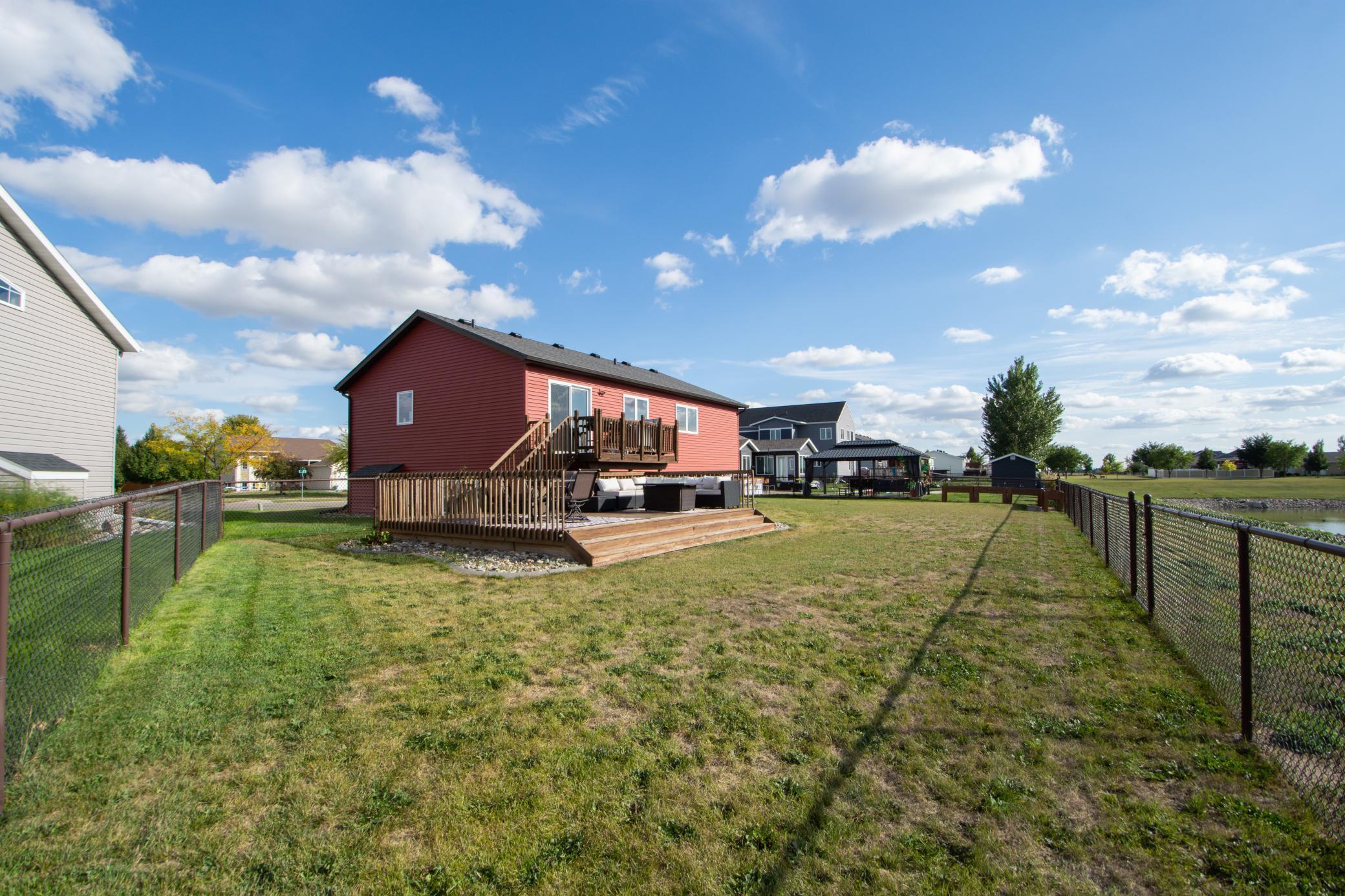 fully fenced yard with pond views