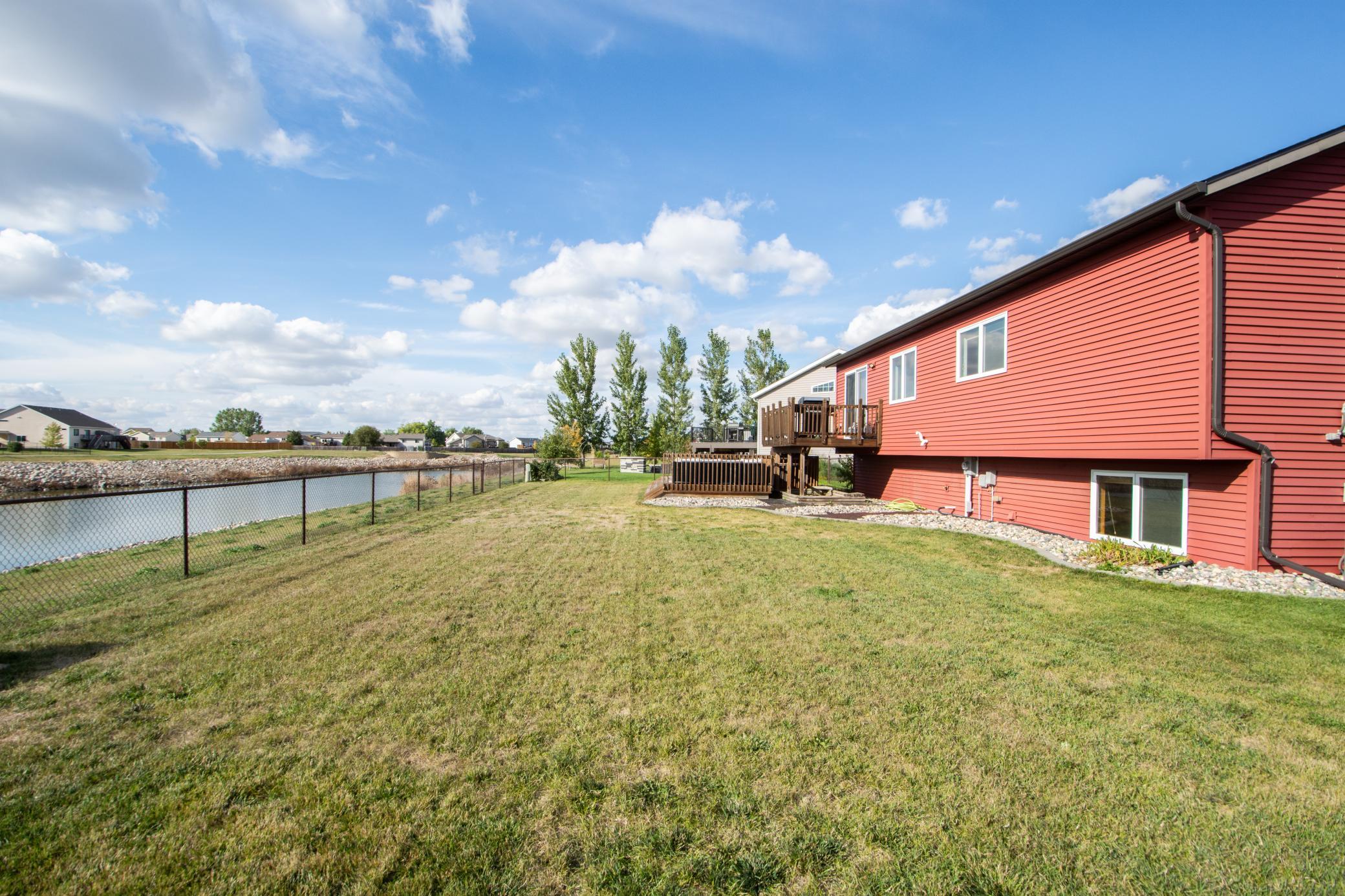 fully fenced yard with pond views