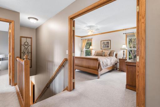 Access the primary bedroom through double French doors