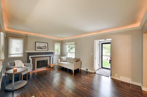 Lovely wood-burning fireplace and lots of windows make this living room a great entertaining space.