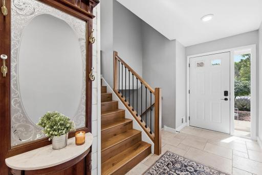 Custom staircase tiled foyer sundrenched sidelight.jpg