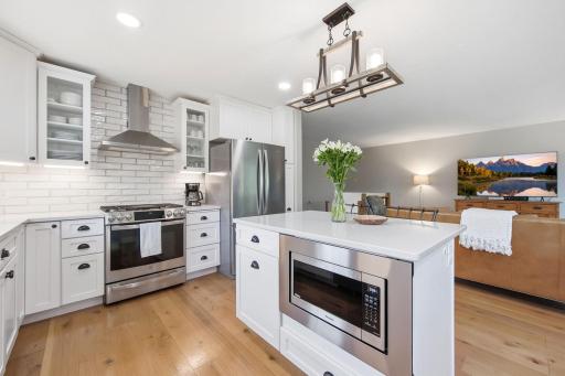 Absolutely stunning open concept kitchen with slow close pull out drawer cabinetry quartz counters.jpg