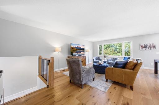 Bright open airy living room with high grade neutral flooring recessed lighting and knockdown ceiling.jpg