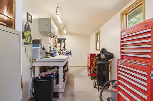 Stunning attached workshop with natural light service doors to garage and backyard.jpg