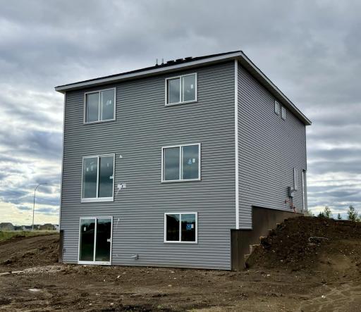3042 Jandura Ave NE- Rear elevation features a walkout lower level. Sod and Irrigation System included.