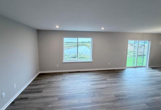 PHOTO OF A DIFFERENT HOME WITH SIMILAR PLAN AND FINISHES. Dining and Great Room.