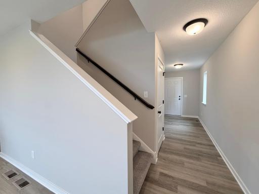 PHOTO OF A DIFFERENT HOME WITH SIMILAR PLAN AND FINISHES. Staircase and foyer.