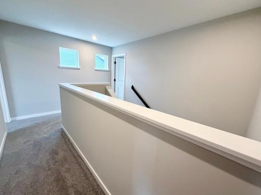 PHOTO OF A DIFFERENT HOME WITH SIMILAR PLAN AND FINISHES. Upper Hallway.