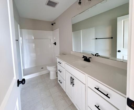 PHOTO OF A DIFFERENT HOME WITH SIMILAR PLAN AND FINISHES. Primary Suite Private Bath.