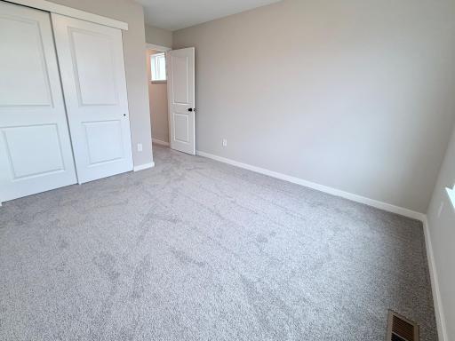 PHOTO OF A DIFFERENT HOME WITH SIMILAR PLAN AND FINISHES. Bedroom 2.