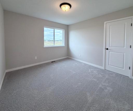PHOTO OF A DIFFERENT HOME WITH SIMILAR PLAN AND FINISHES. Bedroom 2.