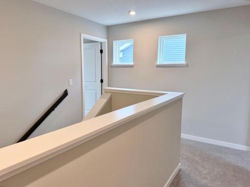 PHOTO OF A DIFFERENT HOME WITH SIMILAR PLAN AND FINISHES. Upper Hallway.