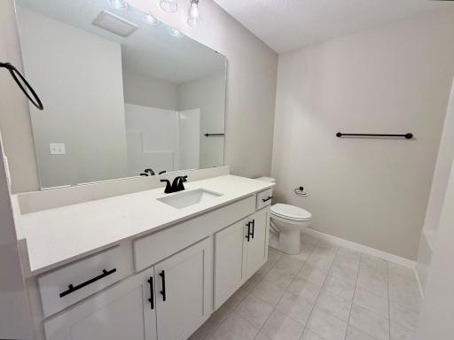 PHOTO OF A DIFFERENT HOME WITH SIMILAR PLAN AND FINISHES. Upper Full Bathroom.