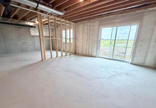PHOTO OF A DIFFERENT HOME WITH SIMILAR PLAN AND FINISHES. Unfinished Walkout Lower Level ready for future finish.