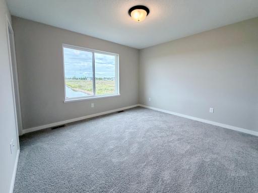 PHOTO OF A DIFFERENT HOME WITH SIMILAR PLAN AND FINISHES. Primary Suite.