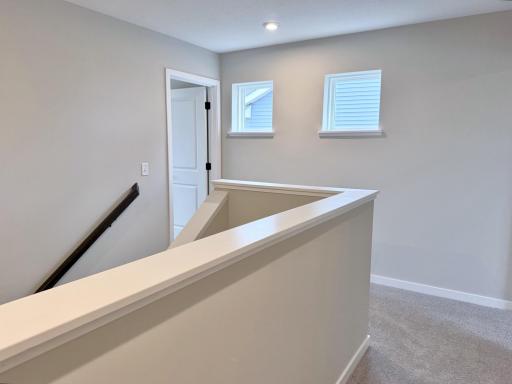 PHOTO OF A DIFFERENT HOME WITH SIMILAR PLAN AND FINISHES. Upper Hallway.