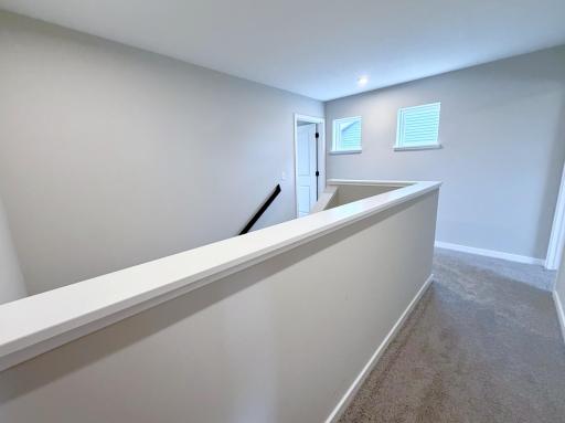 PHOTO OF A DIFFERENT HOME WITH SIMILAR PLAN AND FINISHES. Upper Hallway.